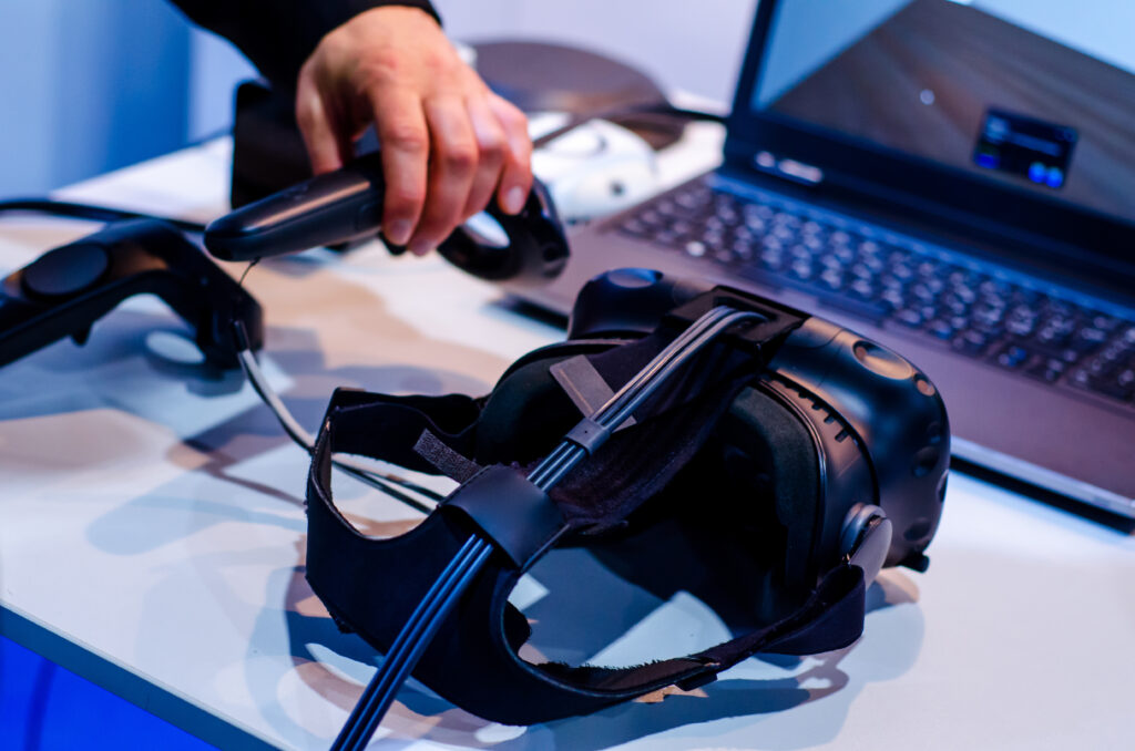 Headset in front of a computer when designing a VR training scenario