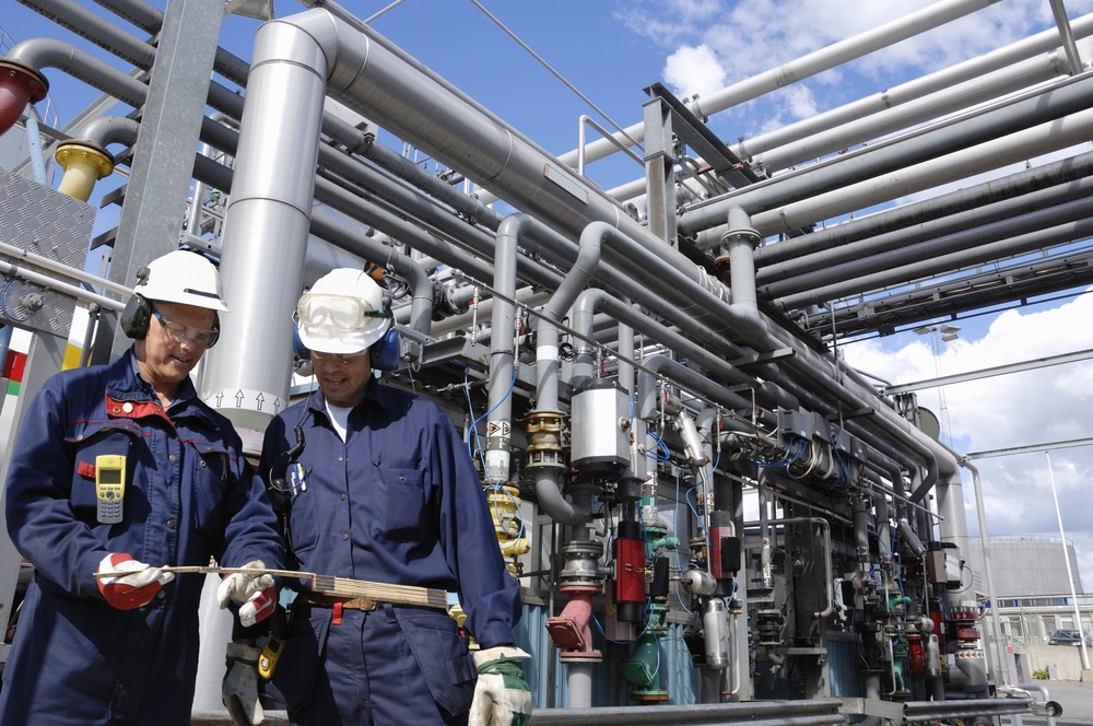Energy sector training with two employees in front of equipment