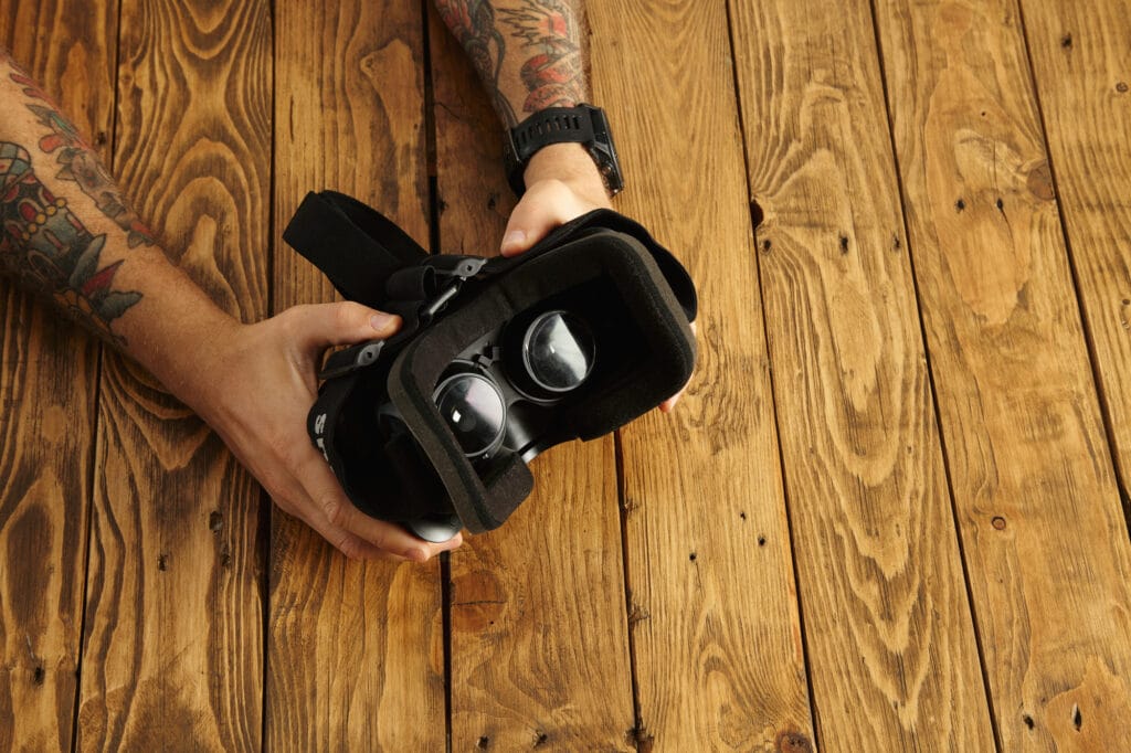 Man holding a VR headset. Find the right VR headset to prevent motion sickness in VR.